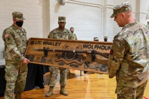 A group of soldiers holding up a wooden box.